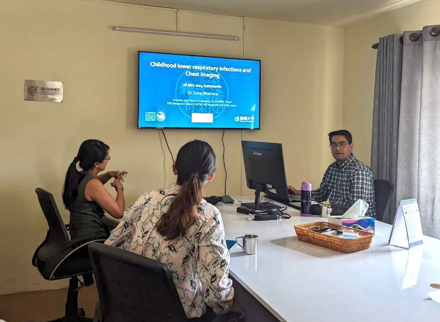 Dr. Bhattarai discussing childhood lower respiratory infections and the role of chest imaging during a seminar at GlohMed meeting hall.